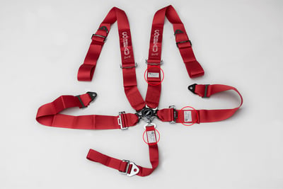Red 5-Point Camlock Harness Belt with locations of label containing manufacture date highlighted.
